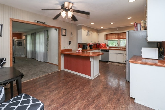 1321 W Hanley Rd, Mansfield, OH 44904 - kitchen with stainless steel appliances, a peninsula, white cabinets, dark wood finished floors, and ceiling fan