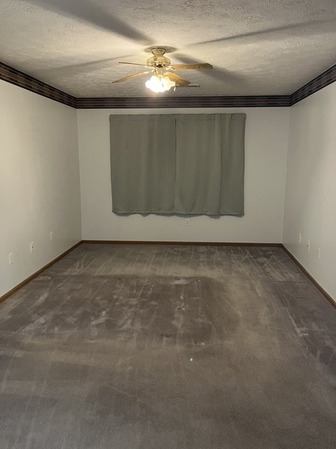 empty room with carpet flooring, a textured ceiling, ceiling fan, and crown molding