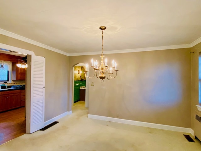 unfurnished dining area featuring ornamental molding, light carpet, and a notable chandelier