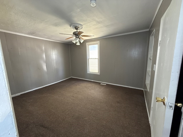603 E Harding Way, Galion, OH 44833 - carpeted spare room featuring a smoke detector, ceiling fan, ornamental molding, and wooden walls