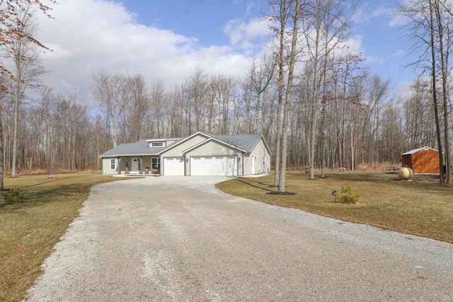 view of front of house with a garage, driveway, and a front lawn