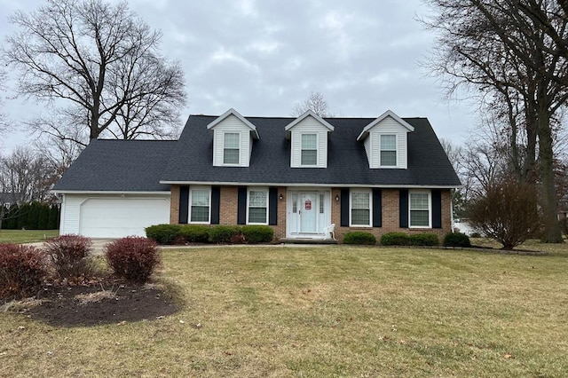 new england style home with a front yard and a garage