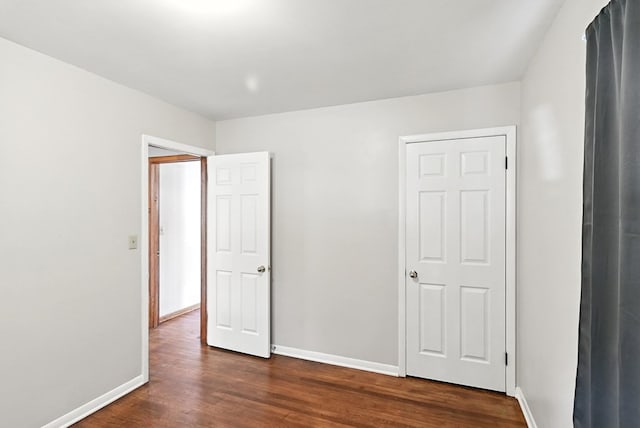 438 Mackey St, Galion, OH 44833 - unfurnished bedroom with dark wood-style flooring and baseboards