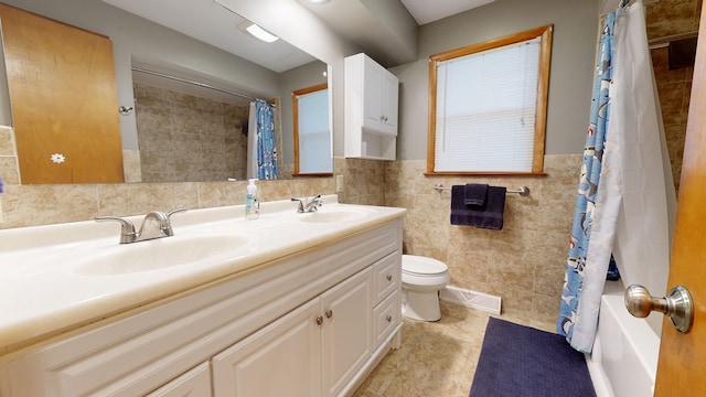 full bathroom with tile walls, vanity, shower / tub combo, toilet, and tile patterned floors