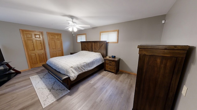 bedroom with ceiling fan and light wood-type flooring