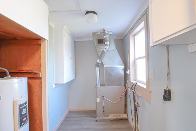 utility room featuring heating unit and water heater