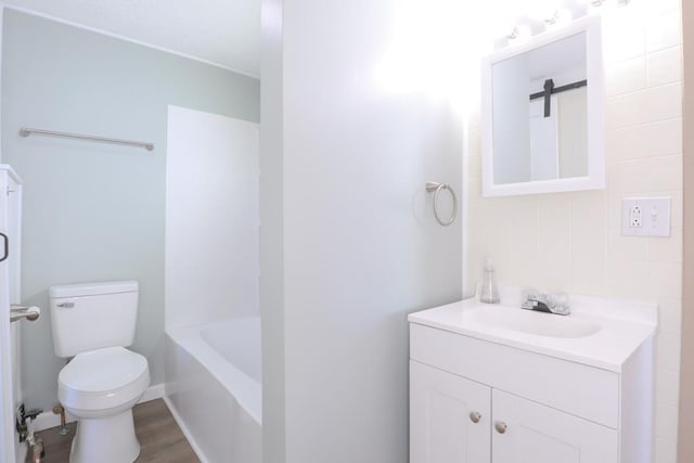 full bath with toilet, vanity, and wood finished floors