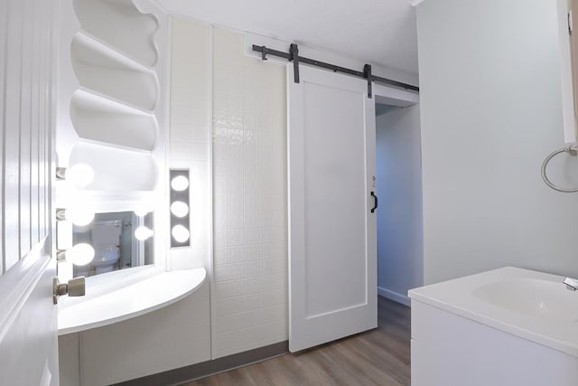 bathroom with a textured ceiling and wood finished floors