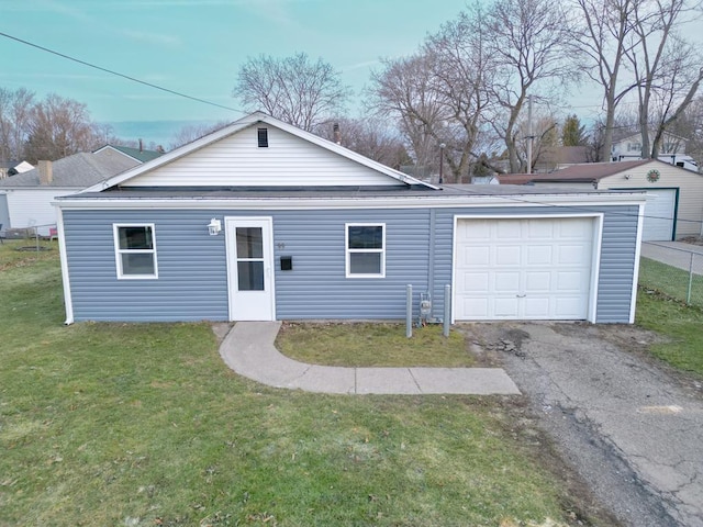 ranch-style house with a garage, driveway, and a front lawn