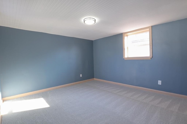 empty room with baseboards and carpet floors