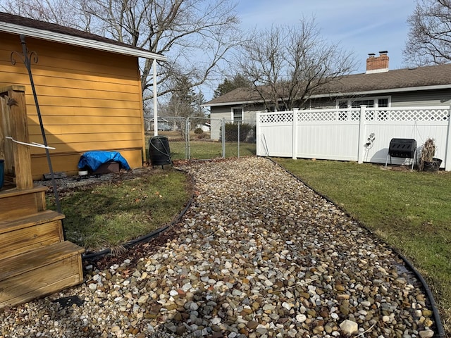 view of yard featuring fence and a gate