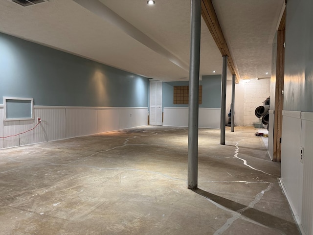 garage featuring a wainscoted wall and visible vents