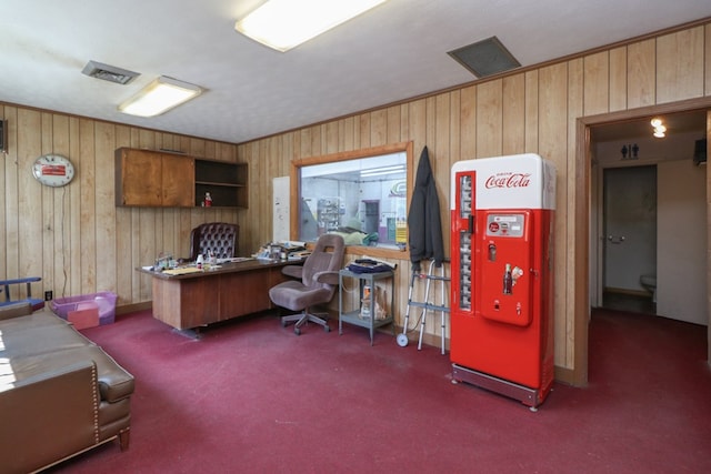 carpeted home office featuring wood walls