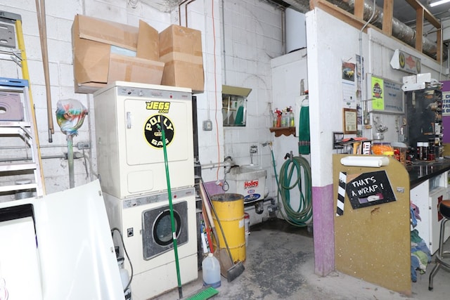 basement featuring stacked washing maching and dryer