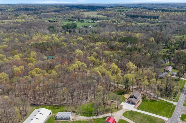 birds eye view of property featuring a view of trees