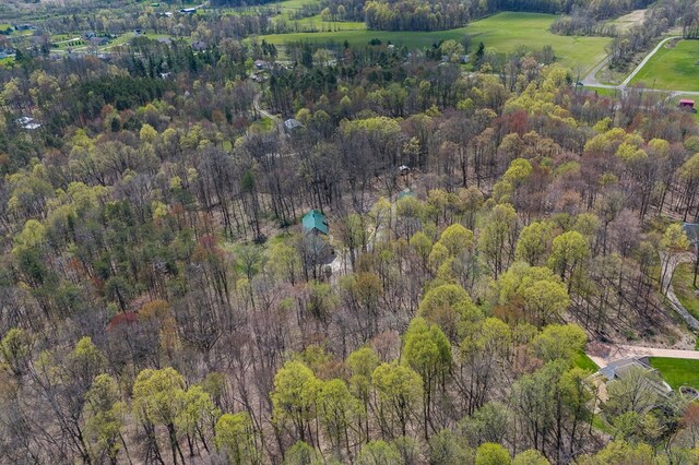 drone / aerial view featuring a wooded view