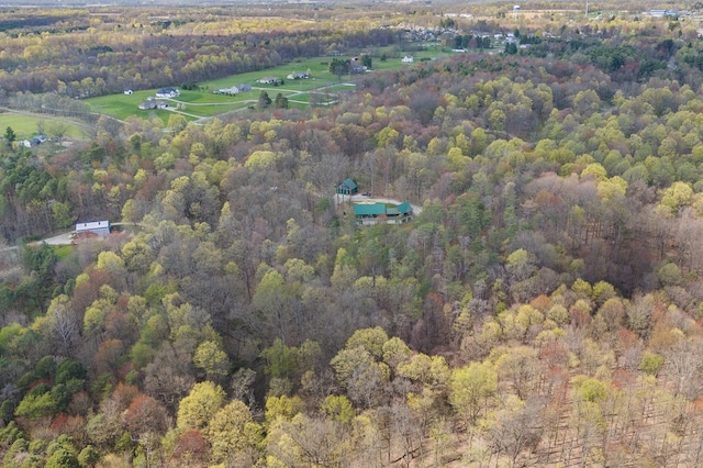 birds eye view of property featuring a wooded view