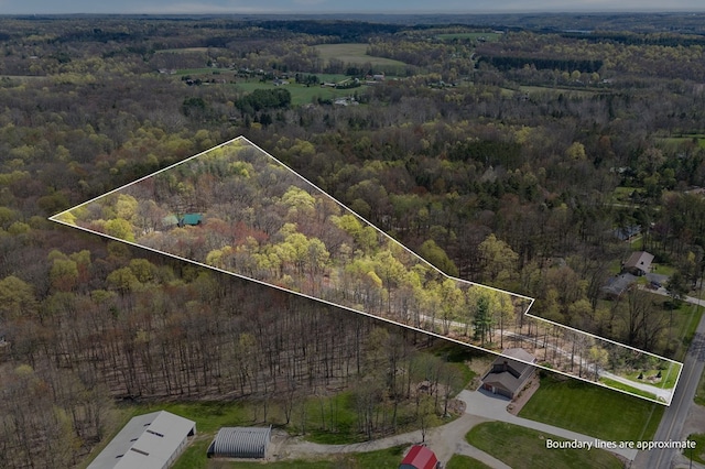 birds eye view of property with a wooded view