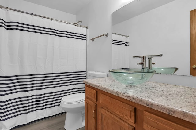 528 N Mulberry St, Street, OH 44902 - bathroom with toilet, vanity, wood finished floors, and curtained shower