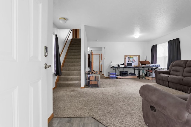 528 N Mulberry St, Street, OH 44902 - carpeted living area featuring stairway, baseboards, and a textured ceiling