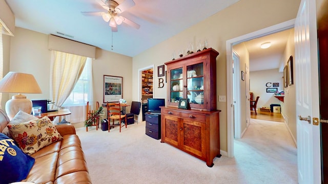 carpeted office with ceiling fan