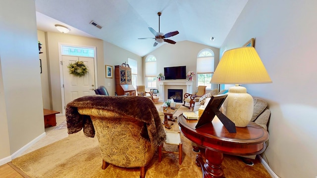 living room with ceiling fan and vaulted ceiling