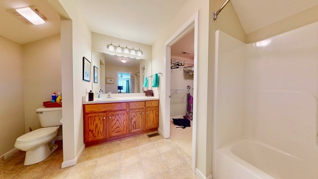 full bathroom with vanity, vaulted ceiling, toilet, and washtub / shower combination