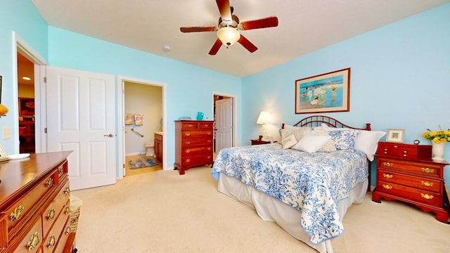 carpeted bedroom featuring ceiling fan and ensuite bathroom