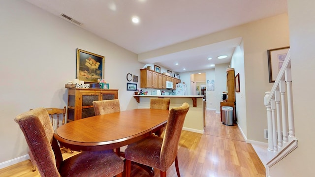 dining space featuring light hardwood / wood-style floors