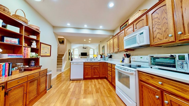 kitchen featuring sink, white appliances, and light hardwood / wood-style flooring