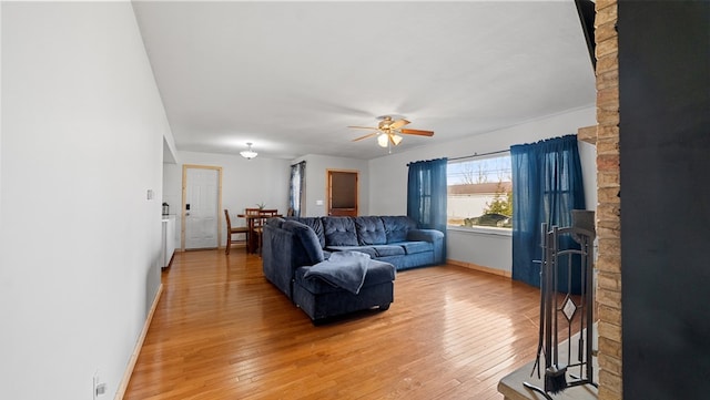 living room featuring hardwood / wood-style floors and ceiling fan