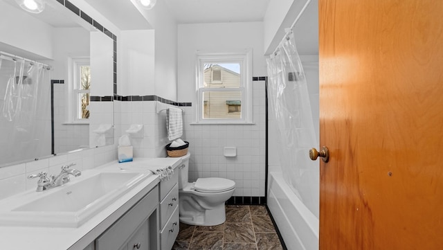 full bathroom with shower / bath combination with curtain, vanity, toilet, and tile walls