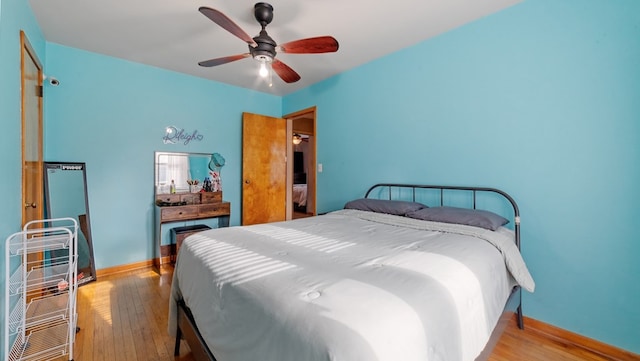 bedroom with ceiling fan and light hardwood / wood-style floors