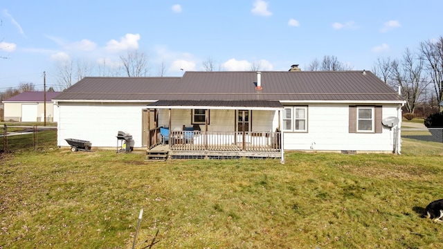 rear view of house with a lawn and a wooden deck