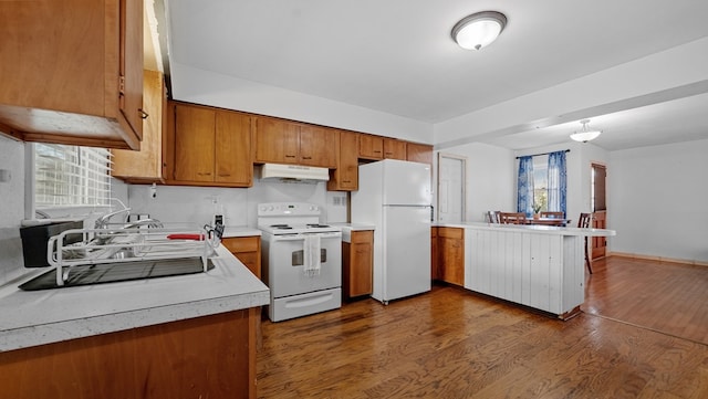 kitchen featuring dark hardwood / wood-style floors and white appliances