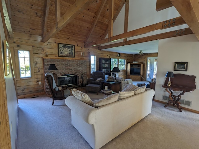 living room with beamed ceiling, plenty of natural light, and wooden walls