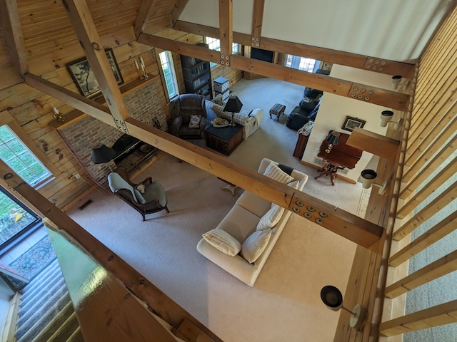 living room with beamed ceiling and a high ceiling