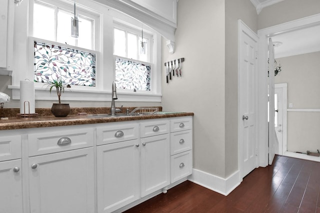 bathroom with hardwood / wood-style floors, ornamental molding, and sink