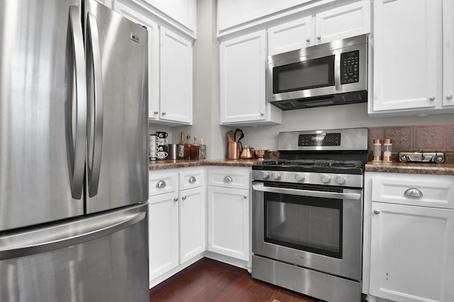 kitchen featuring dark hardwood / wood-style floors, white cabinetry, and appliances with stainless steel finishes