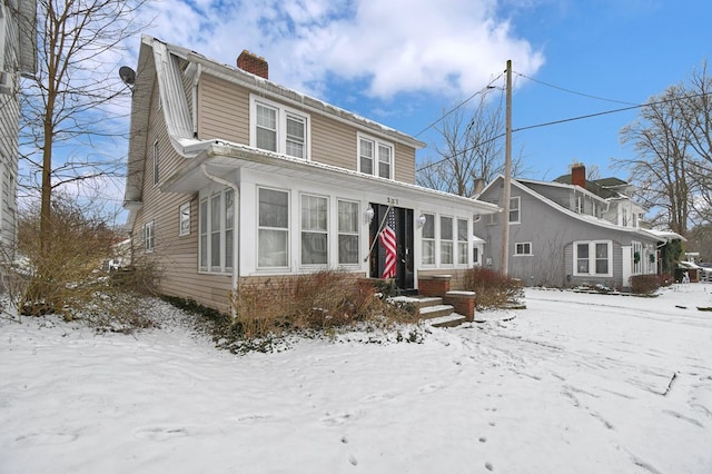 view of front facade with a sunroom