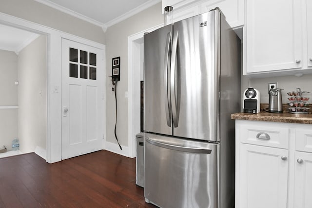 kitchen with white cabinets, stainless steel fridge, dark hardwood / wood-style flooring, and crown molding