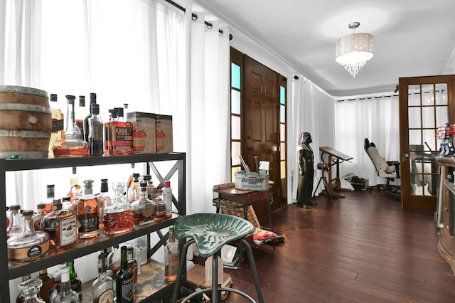 interior space featuring ornamental molding, dark hardwood / wood-style floors, and an inviting chandelier