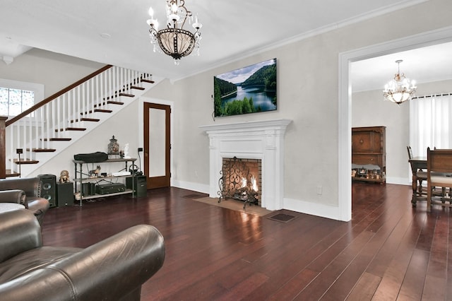 living room featuring dark hardwood / wood-style floors, ornamental molding, and a chandelier