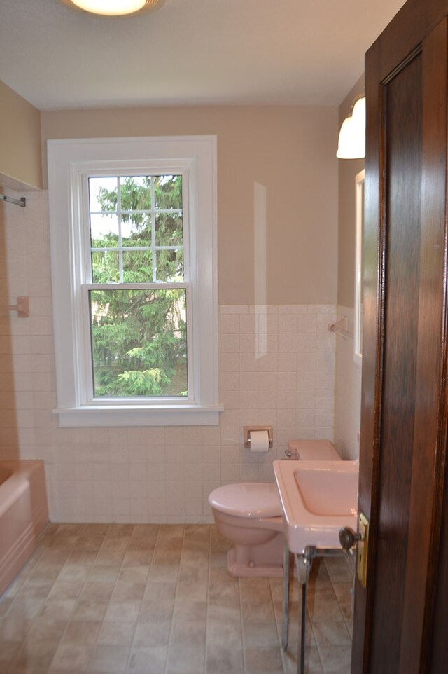 1211 S Sandusky Ave, Bucyrus, OH 44820 - full bathroom featuring tile walls, toilet, wainscoting, and tile patterned floors