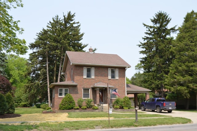 1211 S Sandusky Ave, Bucyrus, OH 44820 - view of front facade with brick siding, a front yard, a chimney, and concrete driveway