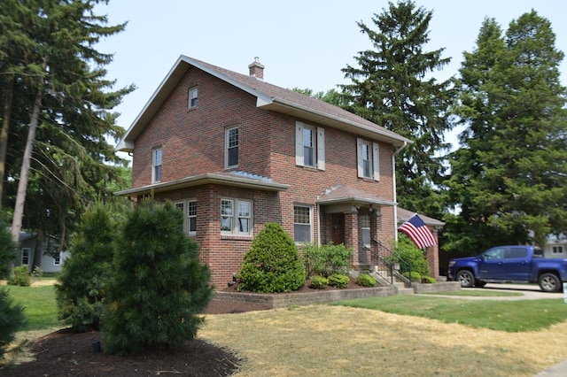1211 S Sandusky Ave, Bucyrus, OH 44820 - view of front of house with brick siding, a chimney, and a front yard