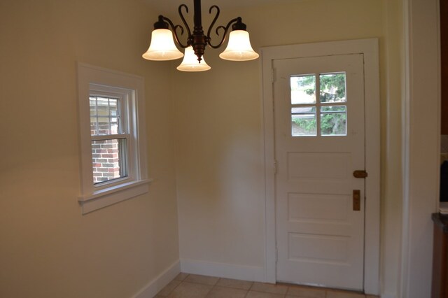 1211 S Sandusky Ave, Bucyrus, OH 44820 - entrance foyer featuring baseboards, light tile patterned floors, and a chandelier