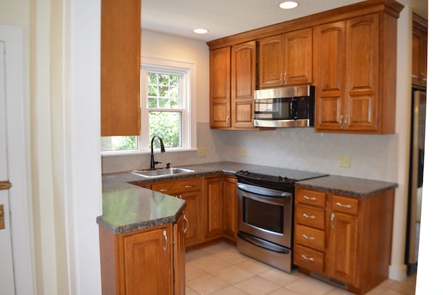 1211 S Sandusky Ave, Bucyrus, OH 44820 - kitchen featuring stainless steel appliances, a sink, brown cabinets, and recessed lighting