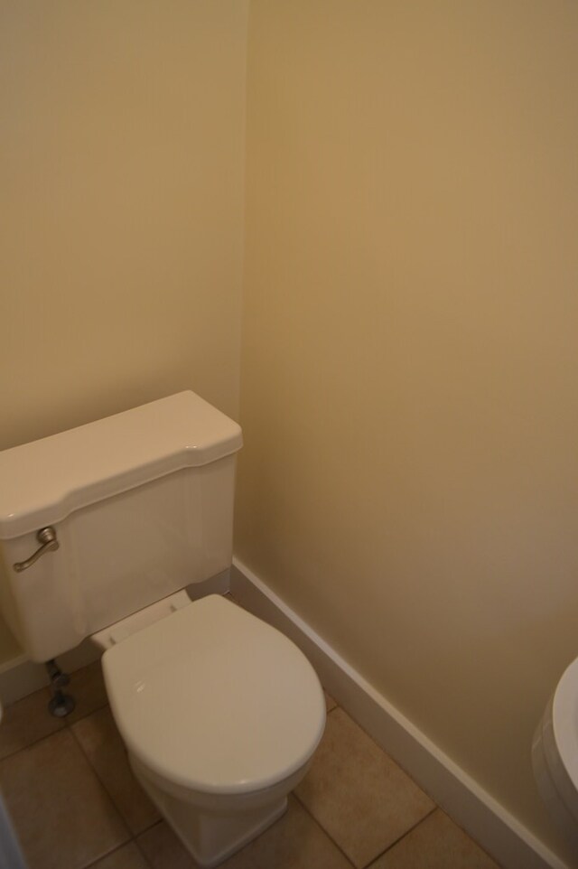 1211 S Sandusky Ave, Bucyrus, OH 44820 - bathroom featuring toilet, tile patterned floors, and baseboards