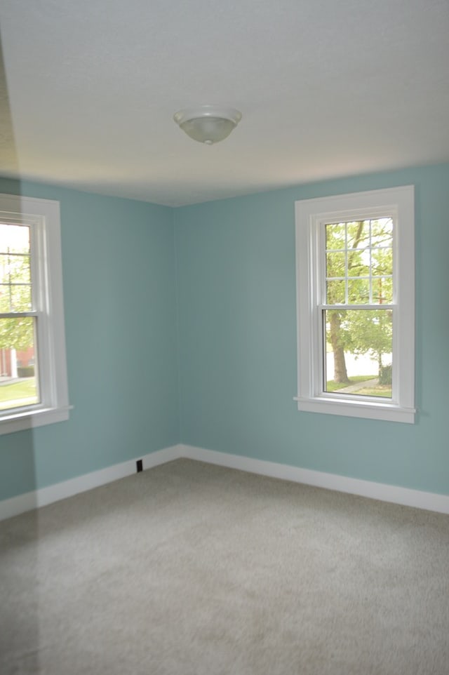 1211 S Sandusky Ave, Bucyrus, OH 44820 - carpeted spare room featuring plenty of natural light and baseboards